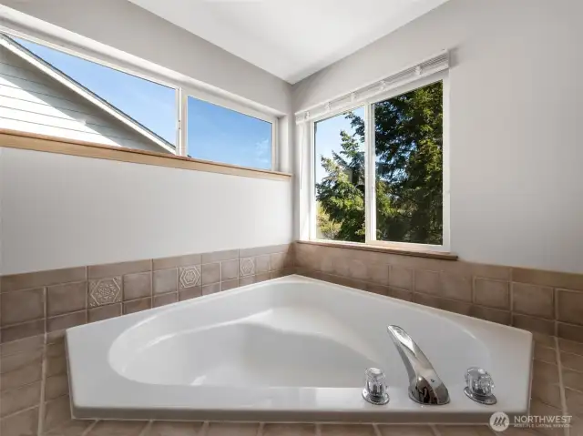 Closer view of the soaking tub with tiled tub deck.