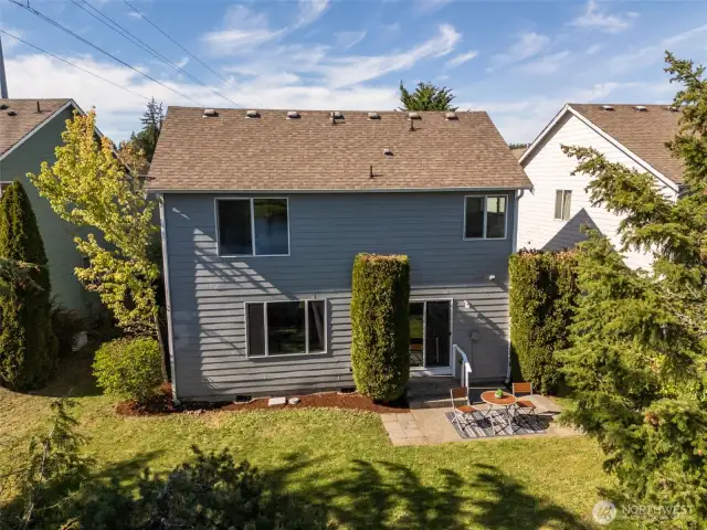 Drone shot shows all the mature trees and patio.