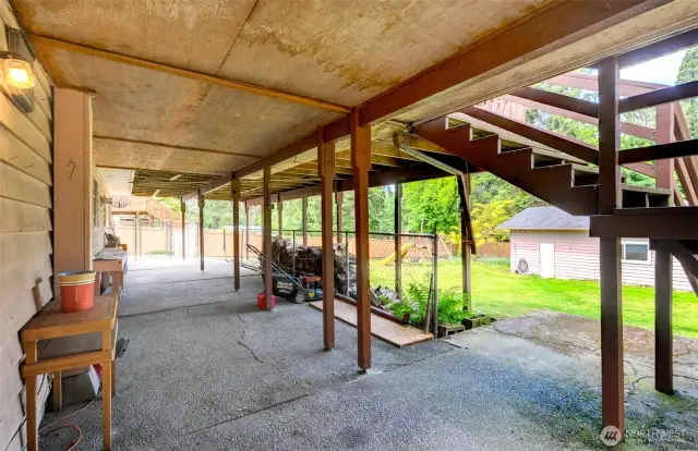 Large patio in back of house, under the upper deck. Fully fenced.