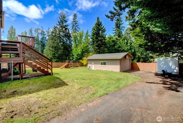A large gated Driveway from front all the way back to wood fence.  Perfect for large toys.  The detached bldg / suite - in the back was at one point a garage.  Open the garage door on side and see space to park a car sideways or remove wall in x room inide.    Very verstile space.