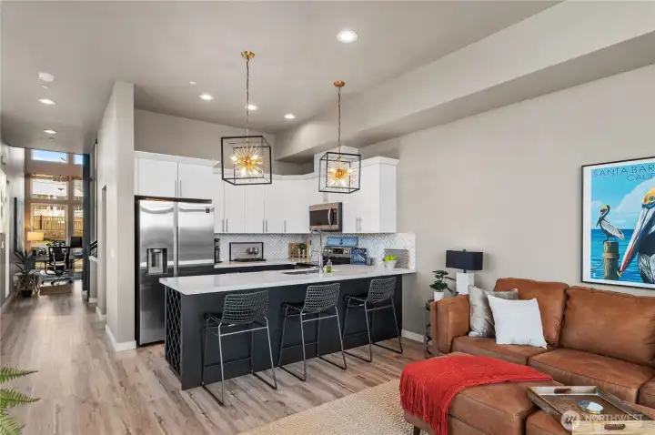 Main level hall view towards the living room just past the half bathroom.