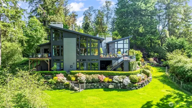 Every angle of this modern masterpiece is intentional. From the geometry of the rooflines to the tiered garden beds, this rear façade speaks to architectural boldness and refined outdoor living.