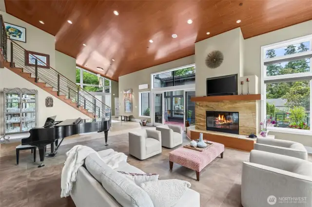 The heart of the home reveals its scale in this dramatic perspective—vaulted ceilings, designer lighting, and spatial fluidity that connects living, art, and entertaining seamlessly.