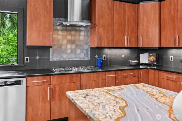 Even the details impress. Rich wood cabinetry, geometric tilework, and clean-lined stainless finishes create a kitchen that’s as performance-ready as it is beautiful.
