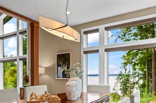 Architectural lighting meets gallery-worthy surroundings. The dining area is a curated moment—bright, stylish, and anchored by ever-changing views.