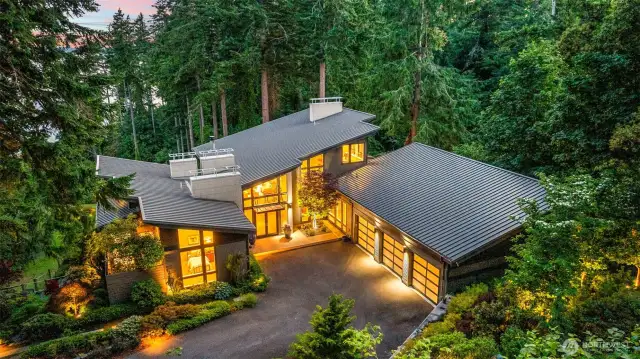As the lights come on, the design speaks for itself. A grand entrance, crisp architectural lines, and a wide drive with attached 3-car garage reflect both function and high design—this is modern living, perfected.