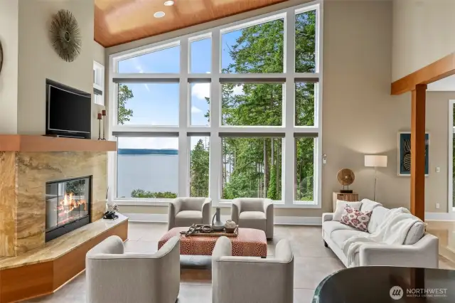 This showstopping living space features a stone-framed fireplace and an artistic expanse of glass with striking Puget Sound views. The architecture is sculptural, the atmosphere is refined, and the setting is simply unforgettable.