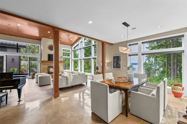 Designed for both ambiance and conversation, the dining room offers treetop and water views through expansive windows. A quiet luxury surrounds the space, making every meal feel like a special occasion.