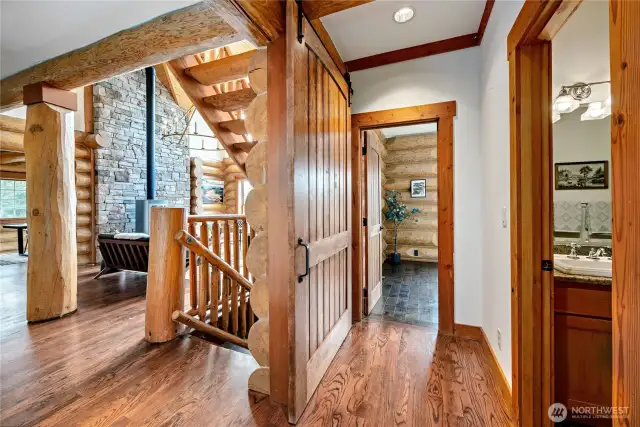 Massive log stairway leads to upper level.