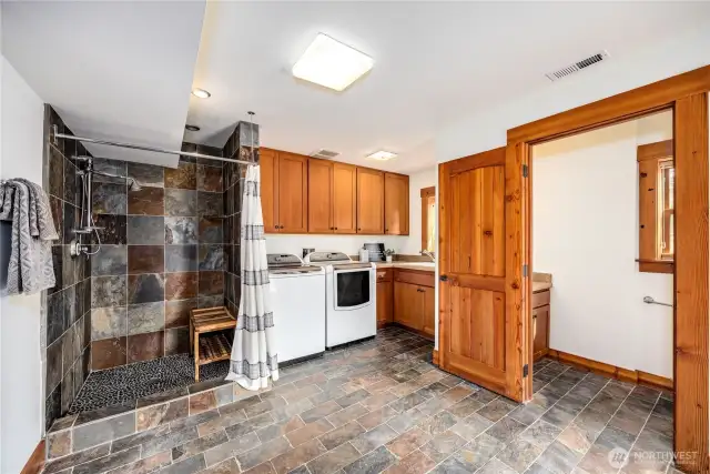 Luxurious Laundry with ample storage, shower and half bath.