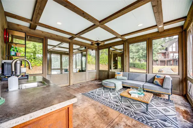 Pool house boasts wet bar and outdoor shower.