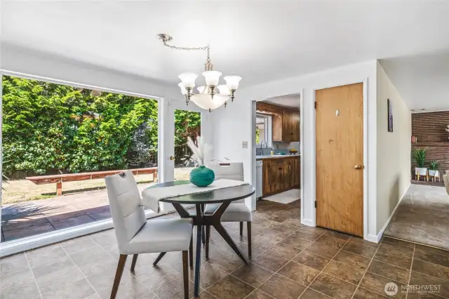 Dining room off the kitchen, with door to the back yard.