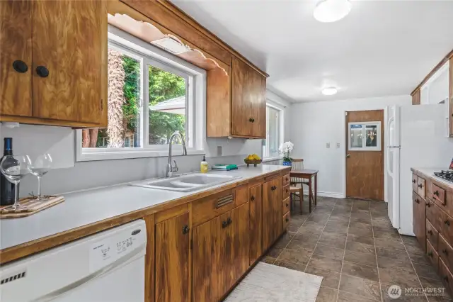 Retro wood cabinets in the kitchen, with eat in space.