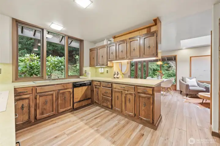 Generous counter space and rich finishes are enhanced by an open layout that flows seamlessly into the family room, creating a warm and light-filled gathering space.