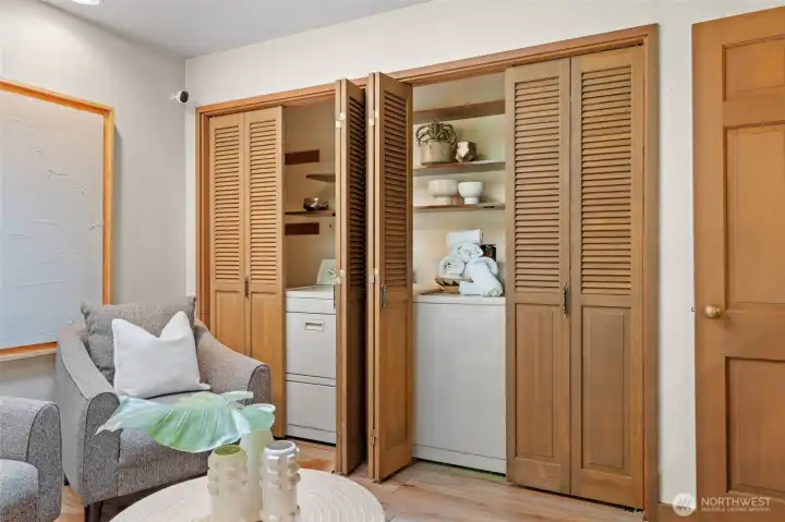 Convenient laundry tucked inside the family room, with hookups ready for a sink and built-in shelving for organization.