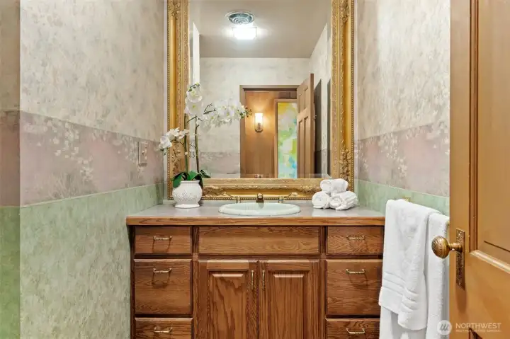 Sophisticated powder room featuring rich wood cabinetry, elegant fixtures, and refined details that elevate the space