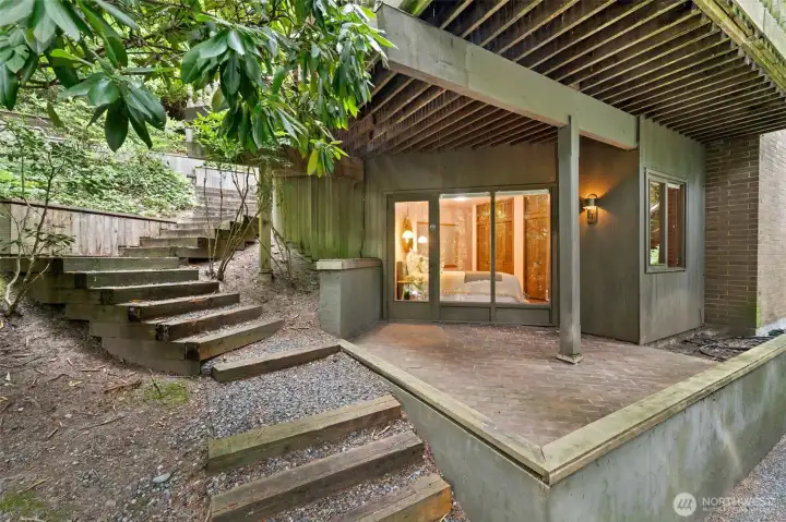 The expansive deck cascades gracefully to the lower-level patio, offering a seamless transition to the private Primary Suite and enhancing the home’s refined sense of retreat.
