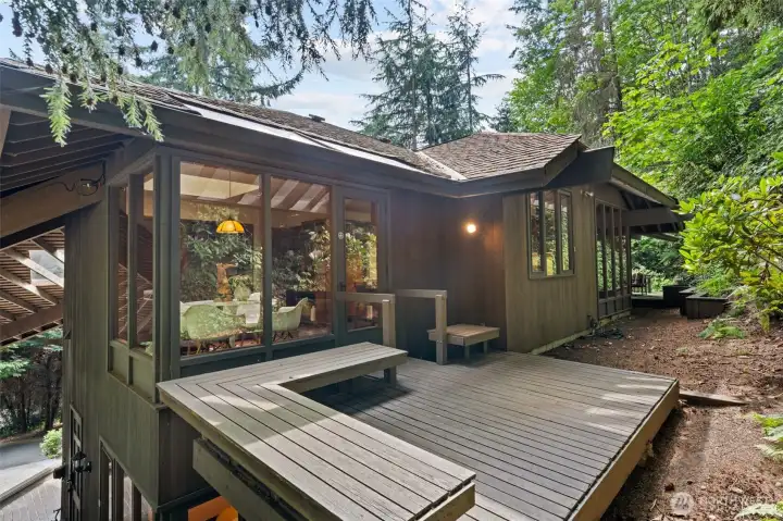Private deck off the family room, perfect for morning coffee or evening relaxation, with direct connection to all of the home’s outdoor living spaces.