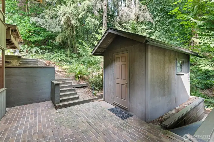 Charming outdoor shed featuring built-in shelving—perfect for organized storage, gardening essentials, or inspiring creative projects.
