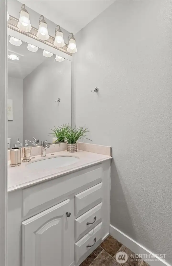 A convenient half bath is perfectly located near the main living areas — ideal for guests & everyday ease.