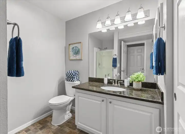 The secondary suite’s 3/4 bath impresses with a roomy vanity and extra counter space — perfect for morning routines or a relaxing evening wind-down.