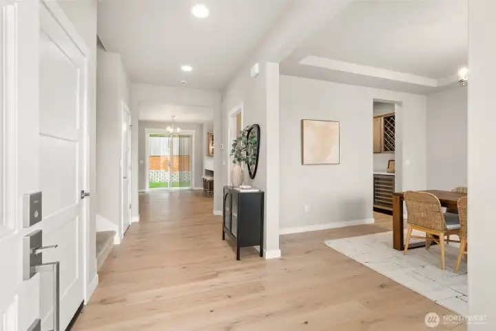 Hardwood flooring included in entry, kitchen, dining and nook area adding warmth and continuity throughout the hallway. Hardwood flooring included in entry, kitchen, dining and nook area adding warmth and continuity throughout the hallway.