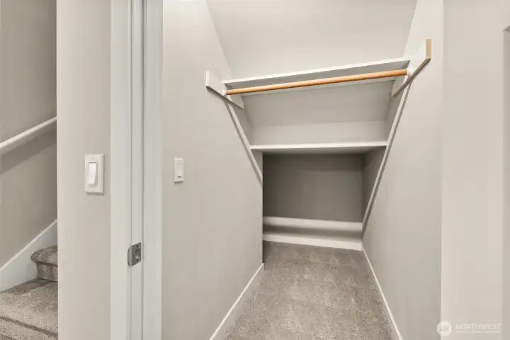 Coat closet with extra storage underneath the stairway. Coat closet with extra storage underneath the stairway.