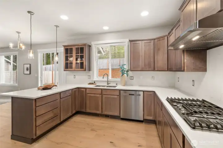 Kitchen opens into nook and a spacious living area with large windows creating a seamless flow ideal for both everyday living and entertaining. Kitchen opens into nook and a spacious living area with large windows creating a seamless flow ideal for both everyday living and entertaining.