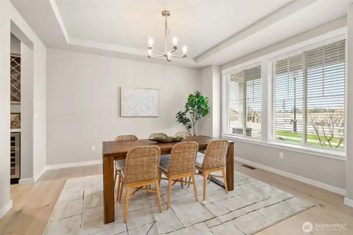 Formal dining with a tray ceiling, lots of natural light and a modern chandelier. Formal dining with a tray ceiling, lots of natural light and a modern chandelier.