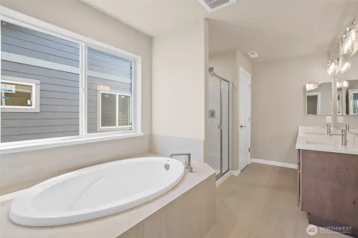 Primary bathroom- 5-piece. Soaking tub with tile surround.