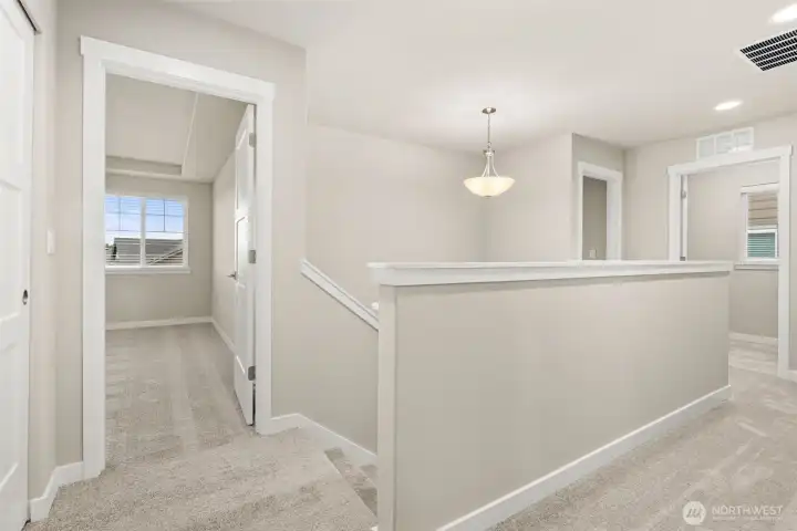 Landing area on second level that connects to the upper-level private rooms and laundry.