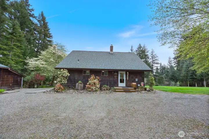 Front of home as you enter from the driveway. To the left is your shop space, equipped with a wood stove.