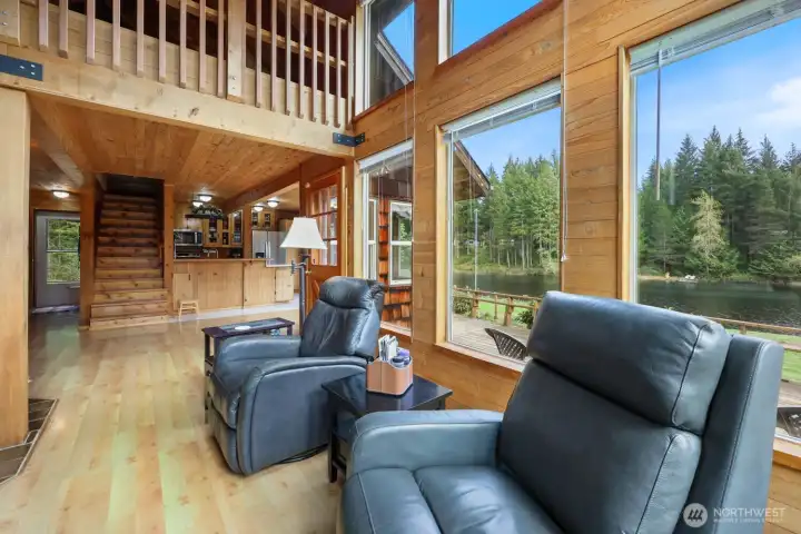 Just past the living room is the entrance to the dining room. The primary bedroom is on the main floor to the left, hallway leads to full bath, laundry space and side door. Just past the living space is a storm door that opens to your vast deck.