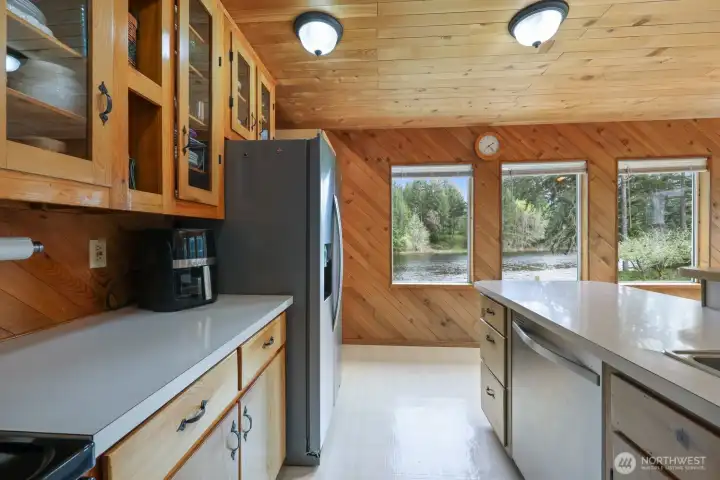 Enjoy uninterrupted lake views from the dining area through the kitchen—no space is without a connection to the water.