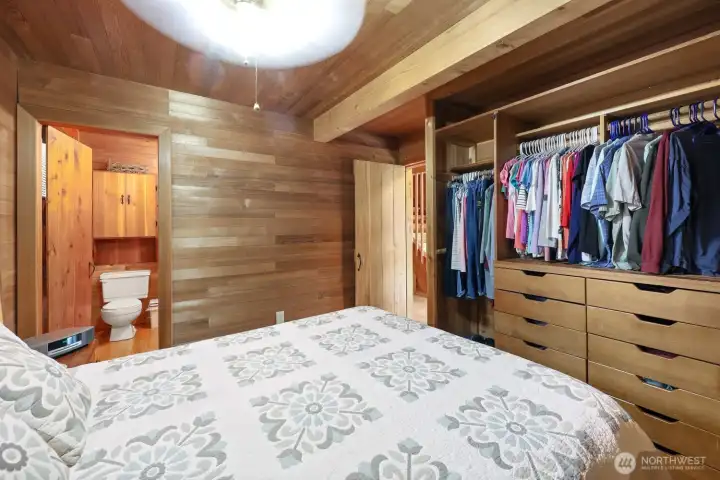 Comfortable primary suite with custom closet storage and a 3/4 ensuite bathroom.