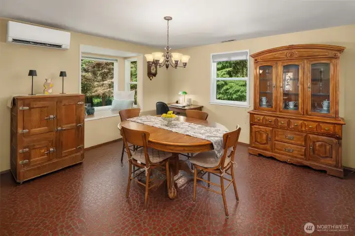 Dining room is spacious and enjoys light from north and west with greenhouse window for seating or plants.