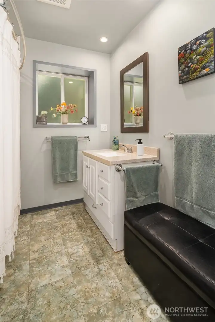 Ground level bath has tub/shower combination.