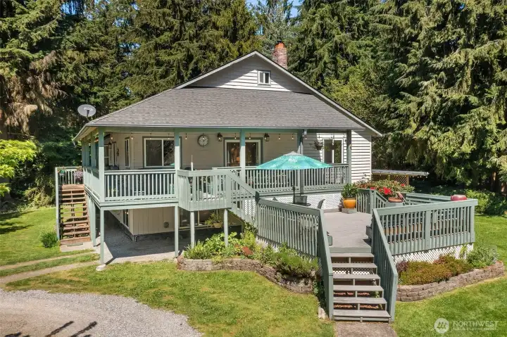 The south side of the home showing the double-decker deck and the entry stair on left.