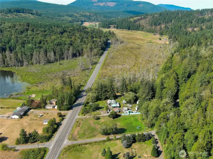The 12+ acres surround the home mid photos. The wetlands are home to many birds and other wildlife. Beaver heaven.