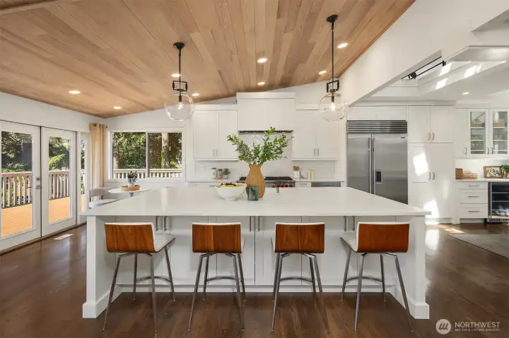 An expansive chef's island paired with luxury appliances anchors a kitchen that serves as a stunning hub for both everyday life and entertaining.