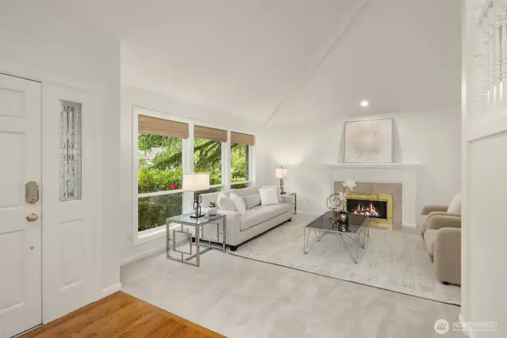 The formal living room is an impressive space to relax or entertain. Large windows on either side of the living/dining space bring in so much light. New carpets throughout the entire home