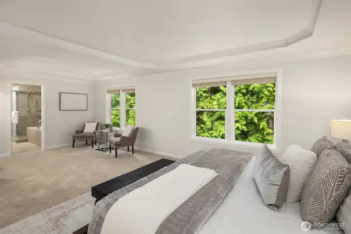 The primary suite, with double doors, is an impressive room - both in size and architectural design.