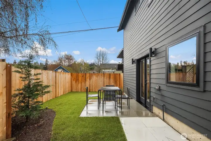 . French doors open to a warm, sun-drenched south-facing patio and fully fenced private yard with low-maintenance turf and curated garden spaces. . French doors open to a warm, sun-drenched south-facing patio and fully fenced private yard with low-maintenance turf and curated garden spaces.