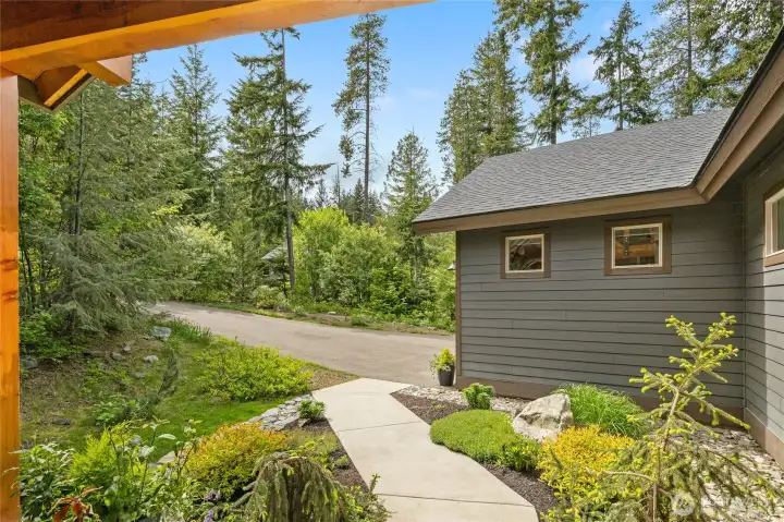 Lush landscaping sets the stage for a gracious welcome to the front door at 636 Trailside.