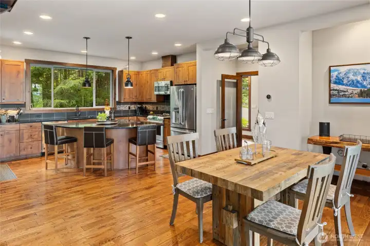 The open-concept kitchen and dining area create the heart of the home — a warm and inviting gathering hub designed for entertaining, conversation, and everyday living.