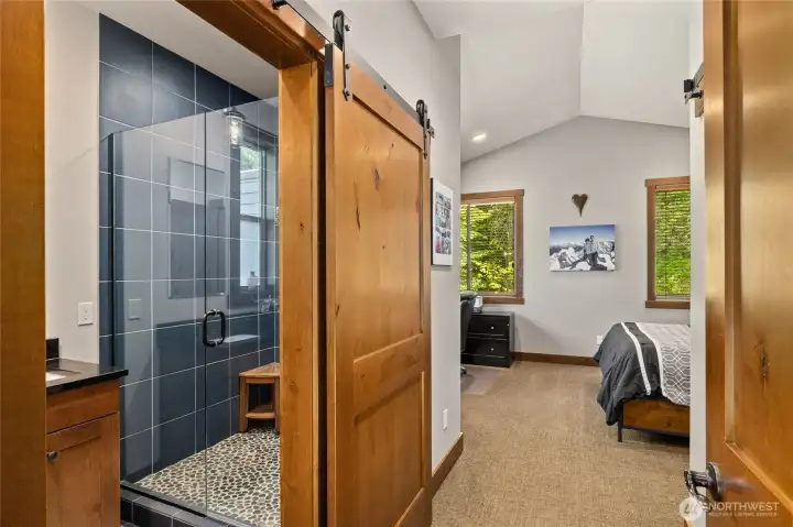 The luxurious main-floor primary suite offers a spacious and serene retreat, thoughtfully designed for both comfort and style.