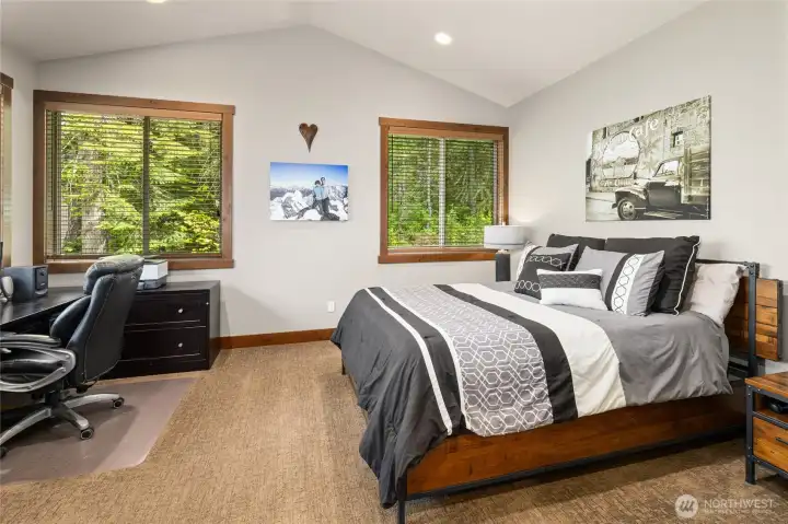 Generous windows invite in natural light and capture the surrounding scenery.