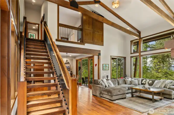 A striking exposed staircase leads to the spacious upper level, adding both architectural character and visual appeal.