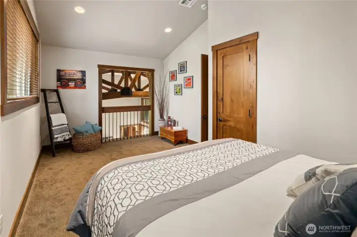 The upper-level flex room offers exceptional versatility, easily serving as a bedroom, media room, or office. A barn door currently opens to the space below, adding architectural interest, while also providing the option to be closed for privacy when desired.