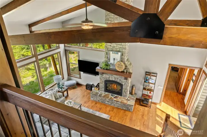 View from the upper level flex room with the barn door in the open position, offering a dramatic connection to the space below and enhancing the home’s open, airy feel.